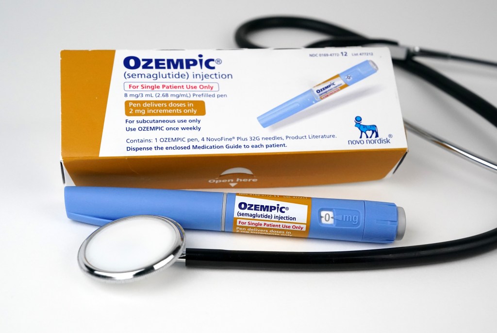 Ozempic package, injection applicator pen and doctor's stethoscope on a table in Hawthorne, NJ.